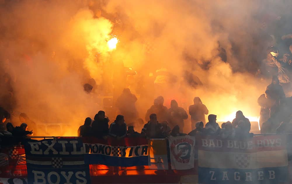 Flares are launched by Croatia supporters during the Euro 2016 qualifying soccer match between Italy and Croatia, at the San Siro stadium in Milan, Italy.