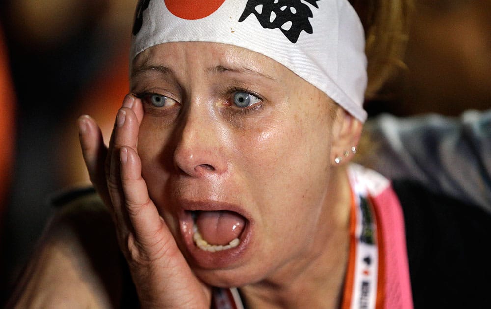 Patty Coaley wipes a tear from her eye after finishing the half marathon during the Rock 'n' Roll Las Vegas Marathon along the Las Vegas Strip, in Las Vegas.