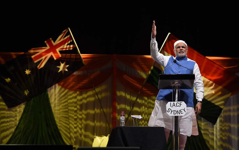 Indian Prime Minister Narendra Modi holds up his hand as he addresses the crowd of Indian community in Australia during a cultural event at Sydney Olympic park in Australia