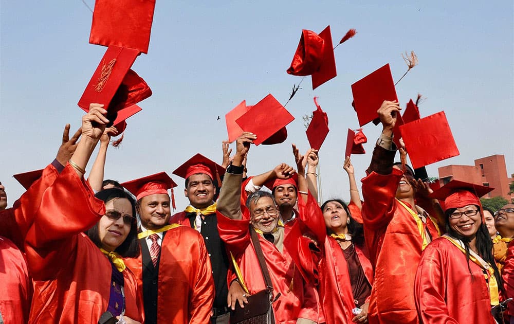 Students jubilate after receiving degree and citations during the annual convocation of Jamia Millia Islamia in New Delhi.