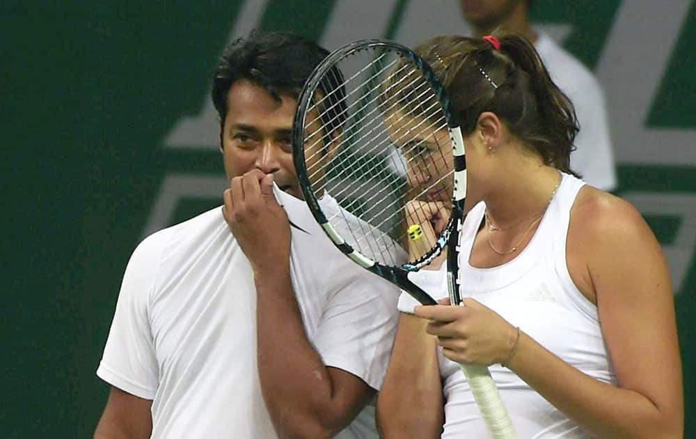 Punjab Marshalls Garbine Muguruza and Leander Paes during the match against Delhi Dreams Jelena Jankovic and Kevin Anderson at the Mixed double of Champions Tennis League in New Delhi.