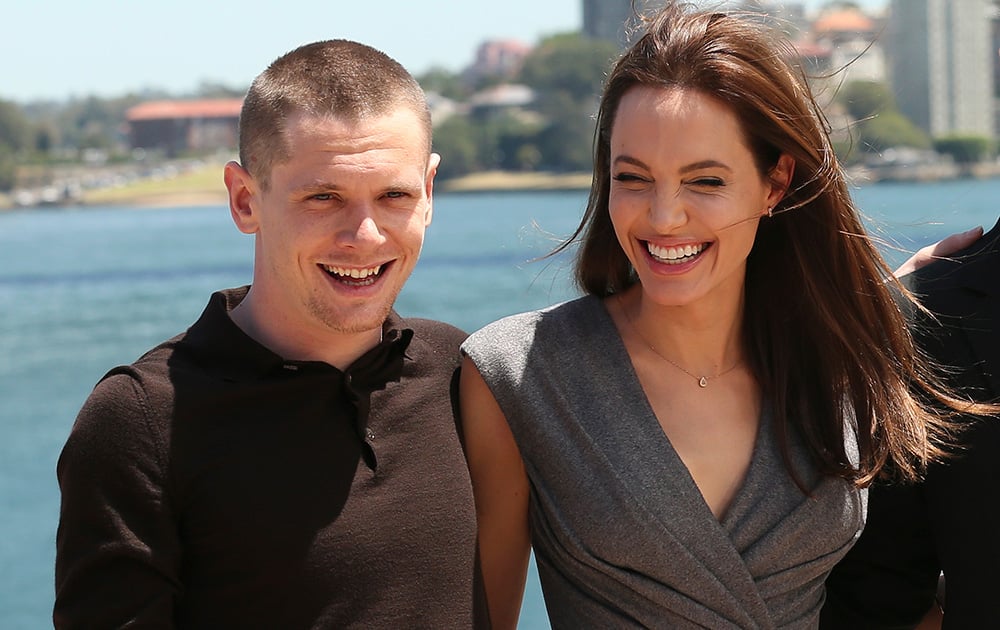 Angelina Jolie, who directed and produced the film 'Unbroken,' poses for a photo with actor Jack O’Connel after a press conference following the movie’s world premiere in Sydney.