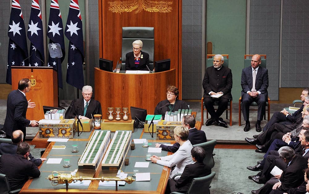 Prime Minister Narendra Modi looks on as Australian Prime Minister Tony Abbott speaks to Speaker of the House Bronwyn Bishop in the Australian Parliament in Canberra.
