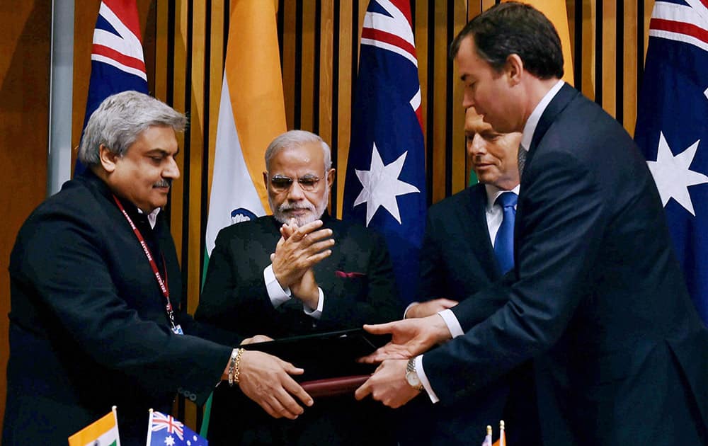 PM Narendra Modi and his Australian counterpart Tony Abbott during signing of an MoU at Australian Parliament in Canberra.