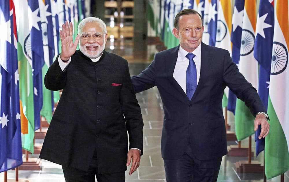 Prime Minister Narendra Modi with his Australian counterpart Tony Abbott waves as he leaves after addressing the Australian Parliament in Canberra.