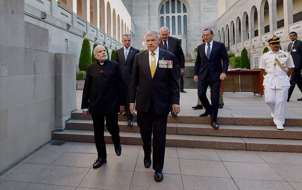 Prime Minister Narendra Modi, escorted by the retired Rear Admiral Ken Doolan leaves after a visit to Australian War Memorial in Canberra.