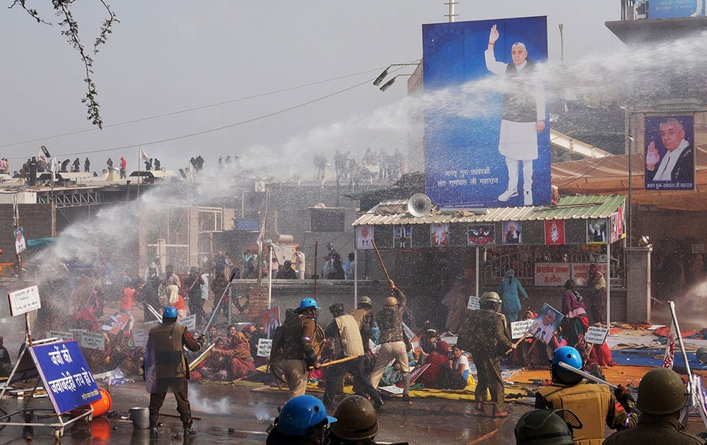 Police use batons and water cannon to disperse supporters, as they storm the ashram of controversial guru Sant Rampal, at Hisar in Haryana.