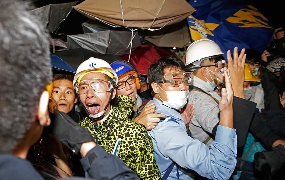Pro-democracy protesters confront police officers outside the Legislative Council in Hong Kong.