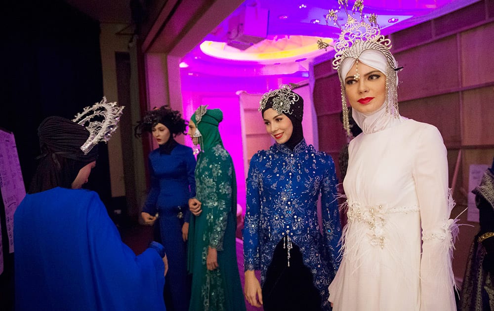 Models wear creations from the Calvin Thoo collection as they wait backstage during the Islamic Fashion Festival in Kuala Lumpur, Malaysia.