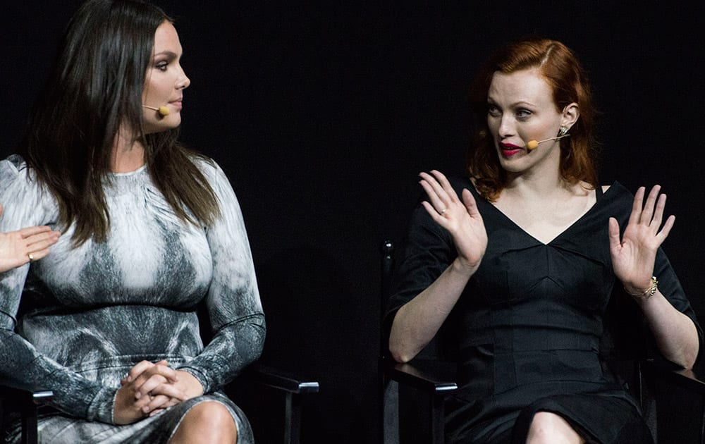 Models Candice Huffine (left) and Karen Elson attend the presentation of the Pirelli 2015 Calendar by Steven Meisel, unveiled in Milan.