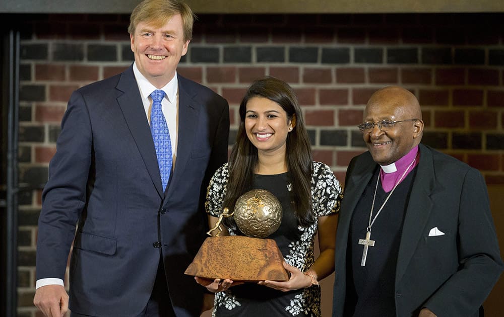 Eighteen-year-old American Neha Gupta poses with Dutch King Willem Alexander,left, after receiving the KidsRights Childrens Peace Prize from South African Archbishop Emeritus Desmond Tutu, right, in The Hague, Netherlands.
