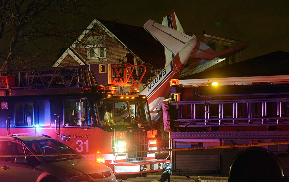 A small twin-engine cargo plane is seen after it crashed into a home on Chicagos southwest side.