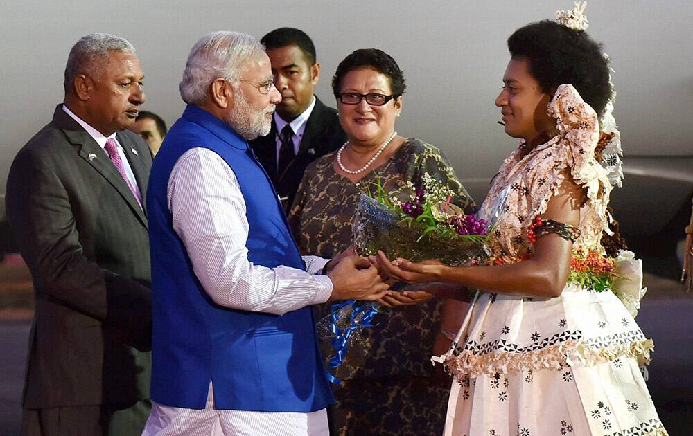 Prime Minister Narendra Modi being welcomed by a Fijian woman in traditional dress at the Nausori International Airport as he arrives in Fiji.