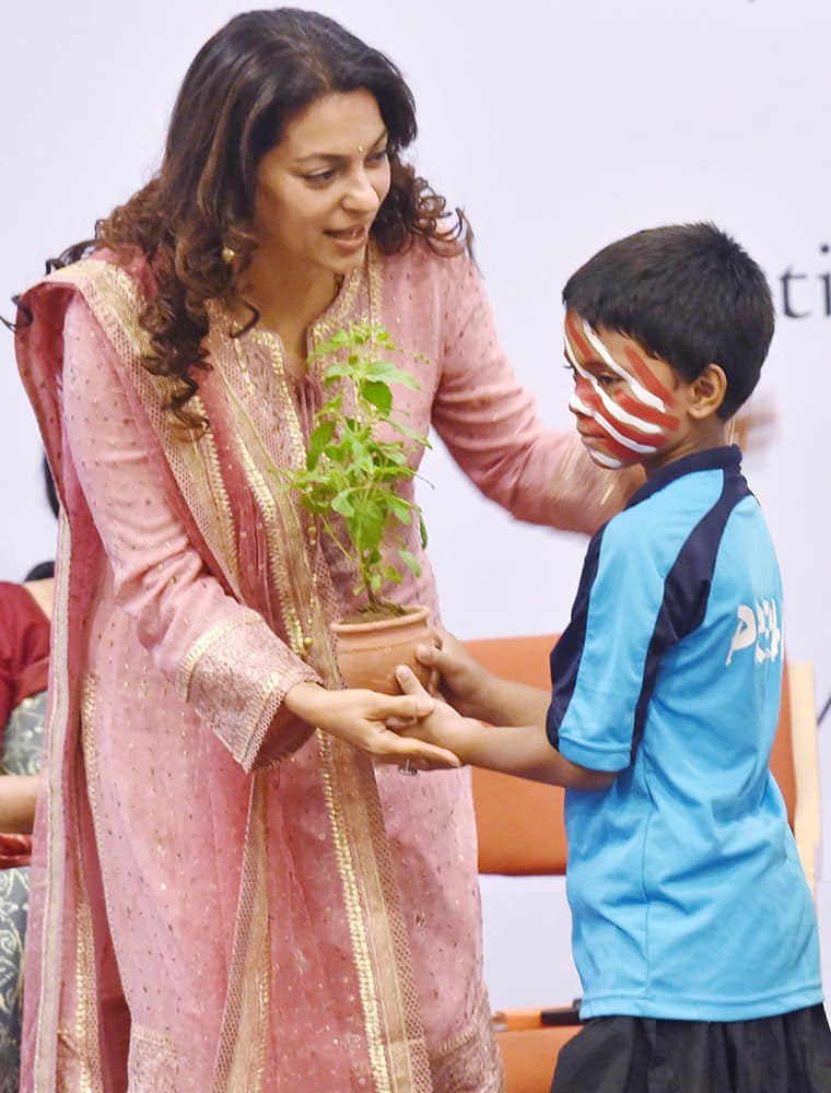 Bollywood actress Juhi Chawla iteracts with a child during an event for prevention of child abuse, in Mumbai .