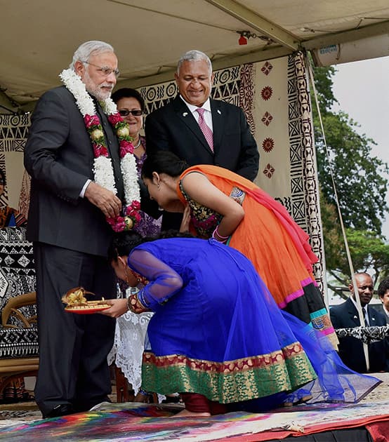 Prime Minister Narendra Modi gives blessings to girls during a traditional welcome ceremony in Fiji.