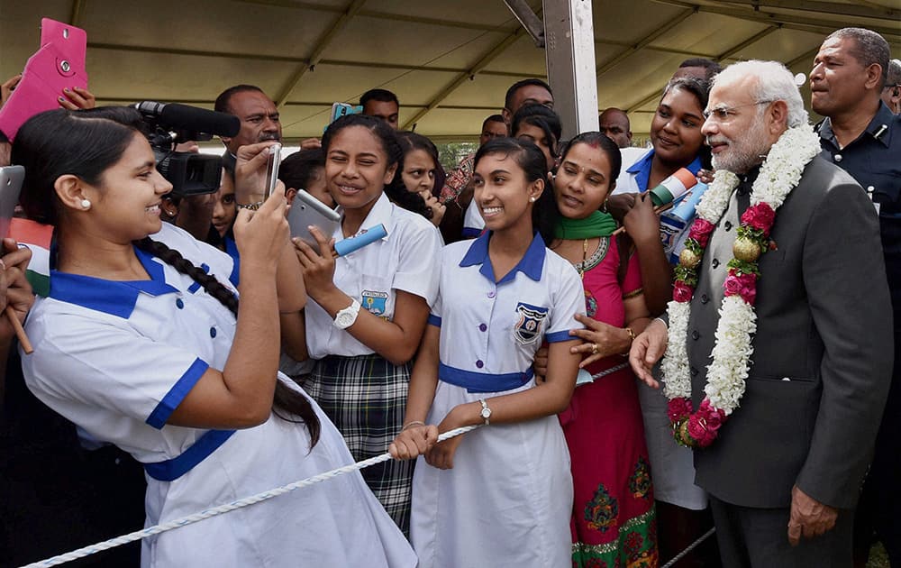 A student makes a selfie with Prime Minister Narendra Modi after a traditional welcome ceremony at Albert Square in Fiji.