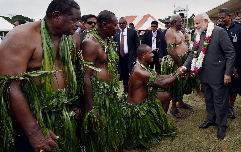 Prime Minister Narendra Modi meets Fijian dancers after a traditional welcome ceremony at Albert Square in Fiji.