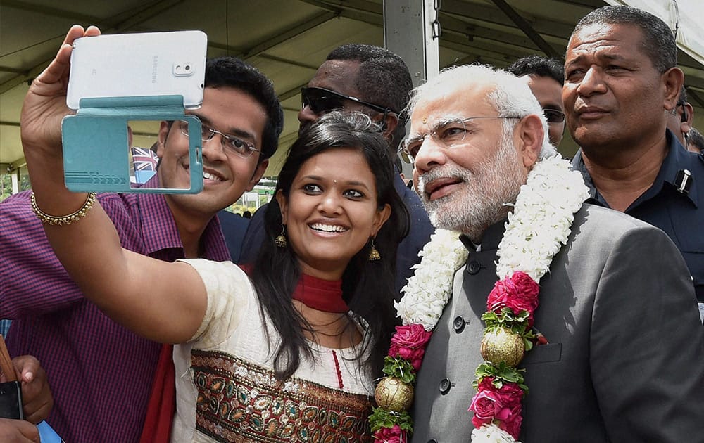 A local girl makes a selfie with Prime Minister Narendra Modi after a traditional welcome ceremony at Albert Square in Fiji.