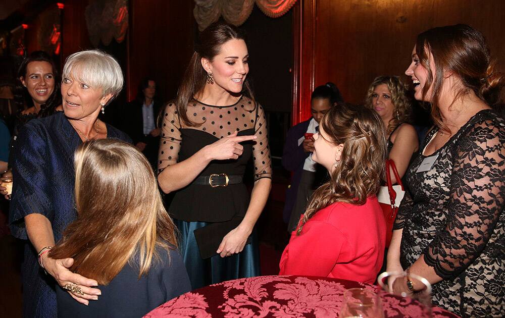 Britain's Kate, Duchess of Cambridge, gestures to finalist in the child champion award Georgia Alvey from Cotsford Junior school, County Durham, at the Place2be Wellbeing in Schools Award at Kensington Palace, London.