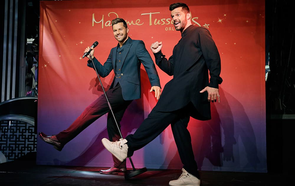 Singer Ricky Martin, right, poses with a wax figure of himself at an an unveiling of the statue at Madame Tussauds in Las Vegas.