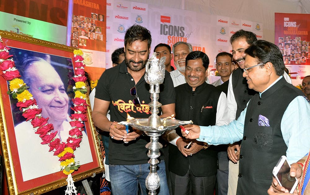 Bollywood actor Ajay Devgn, Lokmat Group chairman and MP Vijay Darda during a function for the release of a coffee table book on Icons of South Maharashtra in Kolhapur.