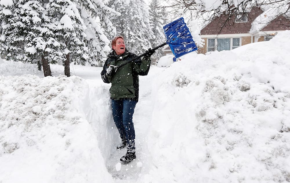 Sue Radka helps shovel out a friends driveway, in Lancaster, New York. 