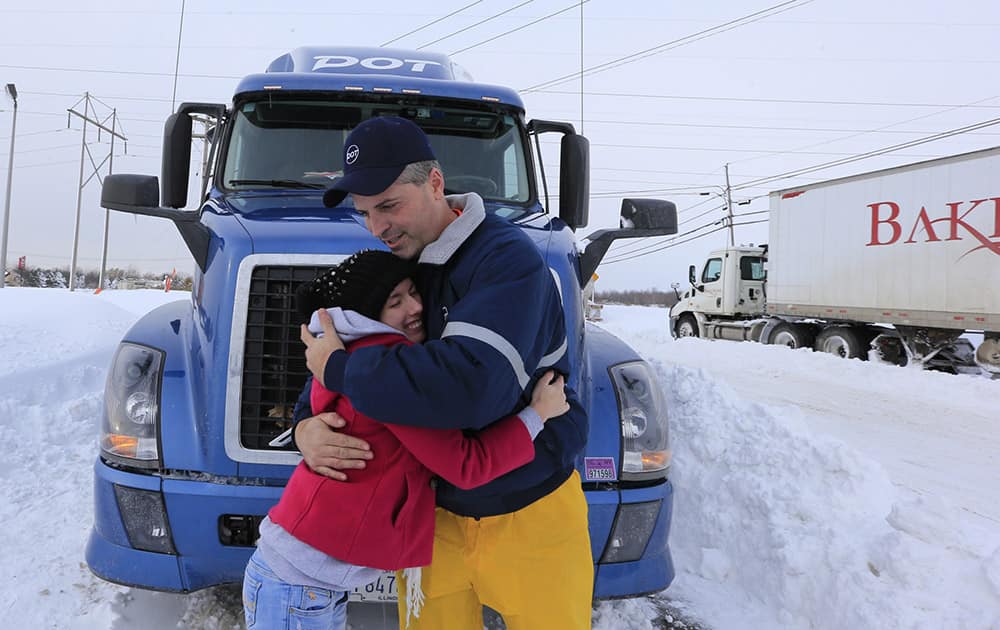 Charles Miller a tractor trailor driver for DOT foods hugs and says goodbye to Hope Clingan, a college student from Cuyahoga Community College in Ohio along camp road in Hamburg, New York.