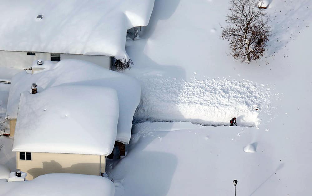 A man digs out his driveway in Depew, New York.