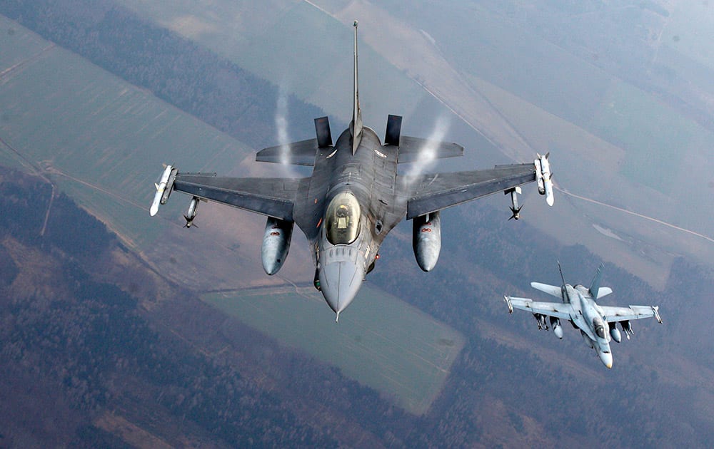 A Portuguese military fighter jet and a Canadian military fighter jet participating in NATO's Baltic Air Policing Mission operate in Lithuanian airspace, NATO, which has 16 fighter jets in the region monitoring Baltic airspace, said it regularly launches jets to identify 'unknown or potentially hostile aircraft' in the proximity of national airspace. 