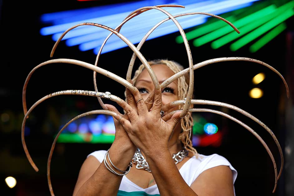 Ayanna Williams displays her 23 inch (58 centimeter) nails at a book launch in London. The 56-year-old stars in a book entitled 'Ripley's Believe it or Not! 2015 Annual, Reality Shock', a compendium of strange but true facts and stories.