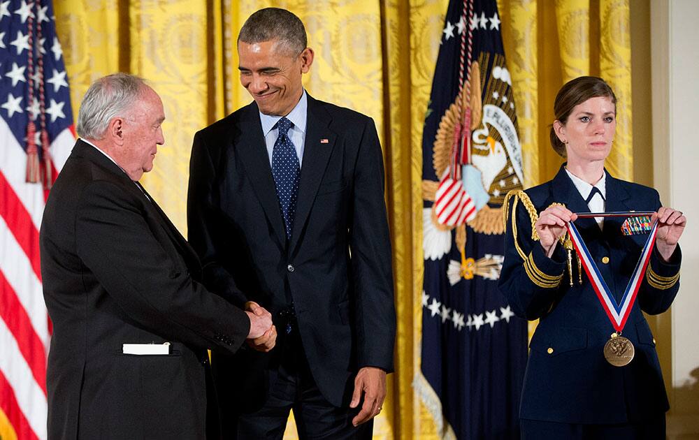 President Barack Obama shakes hands with Thomas Fogarty, of the Forgarty Institute for Innovation, as he awards the National Medal of Technology and Innovation, during a ceremony in the East Room of the White House in Washington.