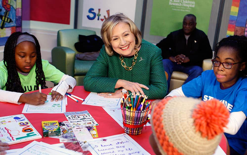 Former Secretary of State Hillary Rodham Clinton, flanked by Adriana Chaney and Carrie-Lynn Grazette, meets with St. Jude children in a clinic before the dedication of The Marlo Thomas Center for Global Education & Collaboration at St. Jude Children’s Research Hospital.