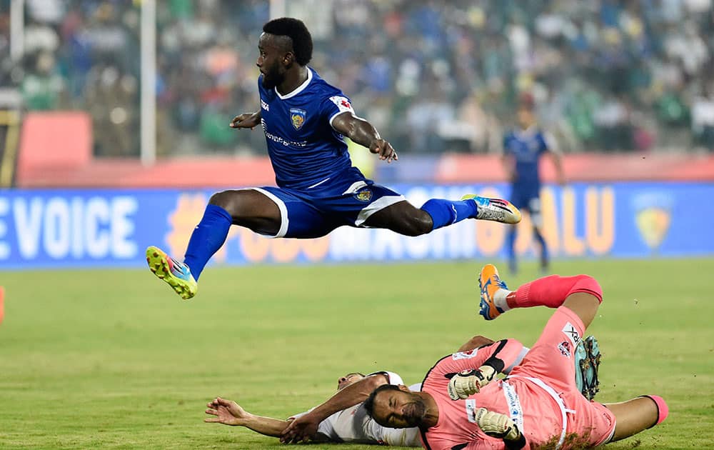 Chennaiyi FC players Mendoza hit a goal against Pune City FC Footballer during their ISL Match in Chennai.