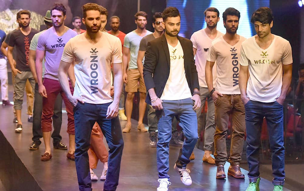 Cricketer Virat Kohli with models launches fashion brand in Mumbai.