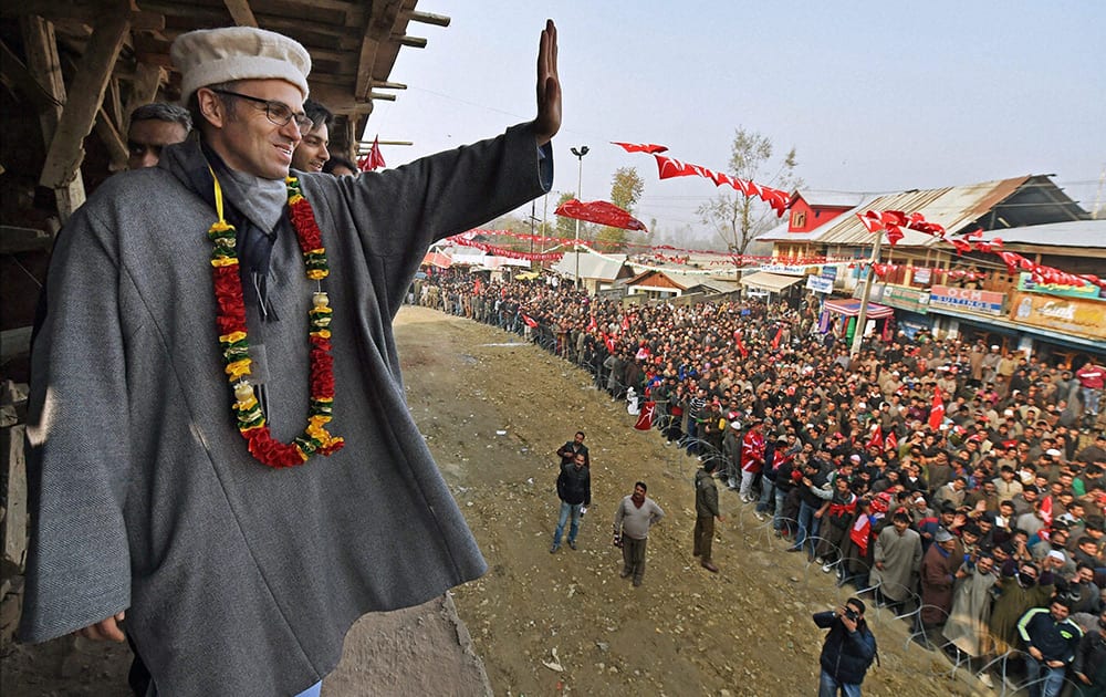 Jammu and Kashmir Chief Minister and National Conference working president Omar Abdullah waves to supporters at a rally after filing nomination papers for Assembly elections at Beerwah in Budgam district.