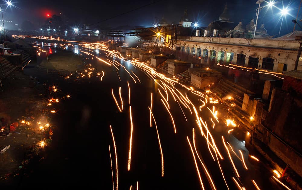 Oil lamps float in the Bagmati River during Bala Chaturdasi festival at the Pashupatinath temple, Katmandu, Nepal.