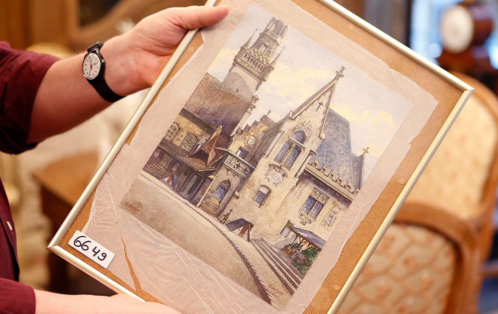 A picture titled “The Old City Hall” that - as the auction house said - was painted by Adolf Hitler is displayed in an auction house in Nuremberg, Germany. The 100-year-old watercolor of Munich’s city hall is expected to fetch at least 50,000 euros (US$ 60,000) at auction this weekend, not so much for its artistic value as for the signature in the bottom left corner: A. Hitler. 