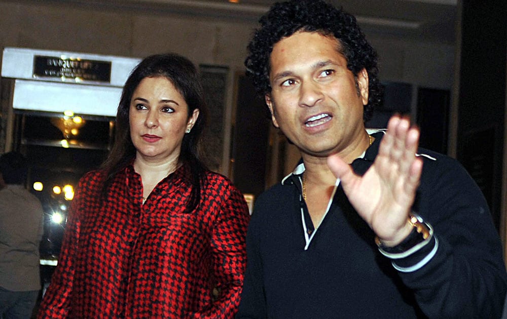 Sachin Tendulkar and his wife Anjali Tendulkar arrive for a felicitation ceremony of cricketer Rohit Sharma who recently hit a double century, in Mumbai.