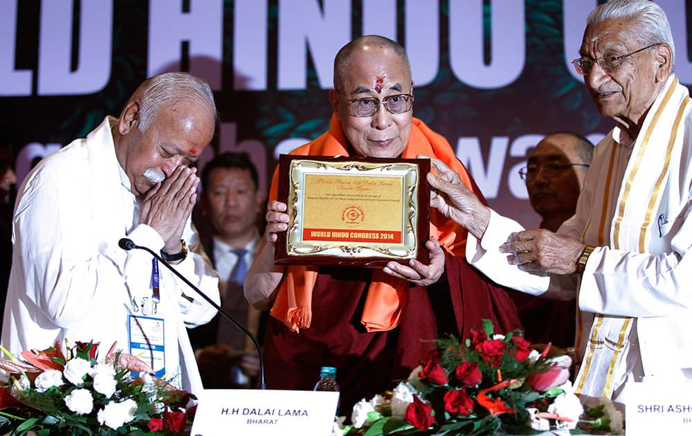 Tibetan spiritual leader the Dalai Lama, is honored with a plaque and a scarf given by Hindu nationalist Rashtriya Swayamsevak Sangh (RSS) chief Mohan Bhagwat and Vishwa Hindu Parishad leader Ashok Singhal during the World Hindu Congress 2014 in New Delhi.