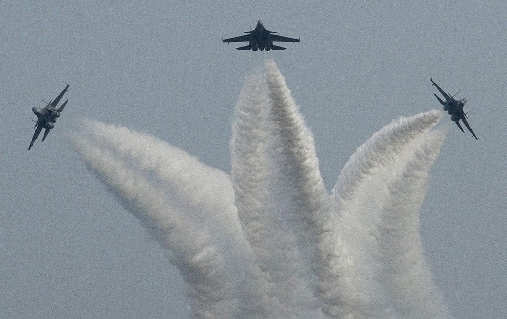 Indian Air Force (IAF) Sukhoi Su-30 fighter aircrafts make a formation in the shape of a trident during a parade at an airbase in Tezpur.