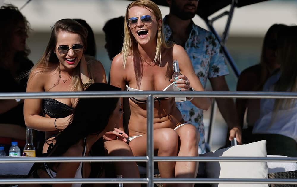 Women on a yacht watch the first free practice at the Yas Marina racetrack in Abu Dhabi, United Arab Emirates.