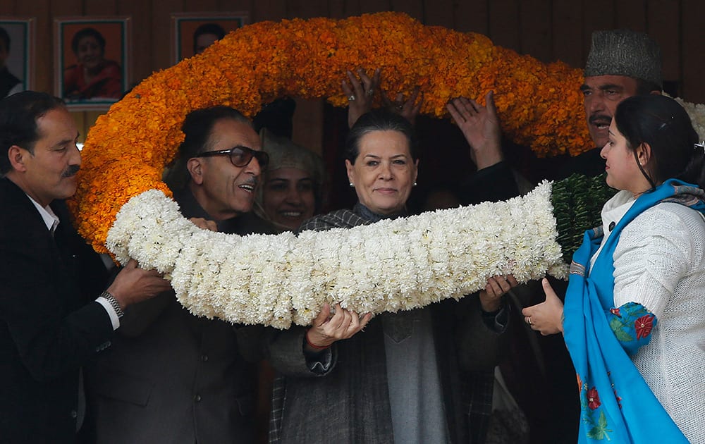 Congress party President Sonia Gandhi, receives a giant floral garland during an election rally at Bandipora, about 75 kilometers (47 miles) from Srinagar.