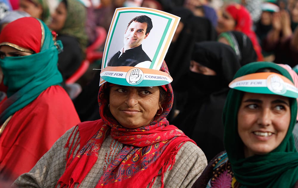 A Kashmiri supporter of the Congress party sports a portrait of party Vice President Rahul Gandhi on her head during an election campaign rally at Bandipora, about 75 kilometers (47 miles) from Srinagar.