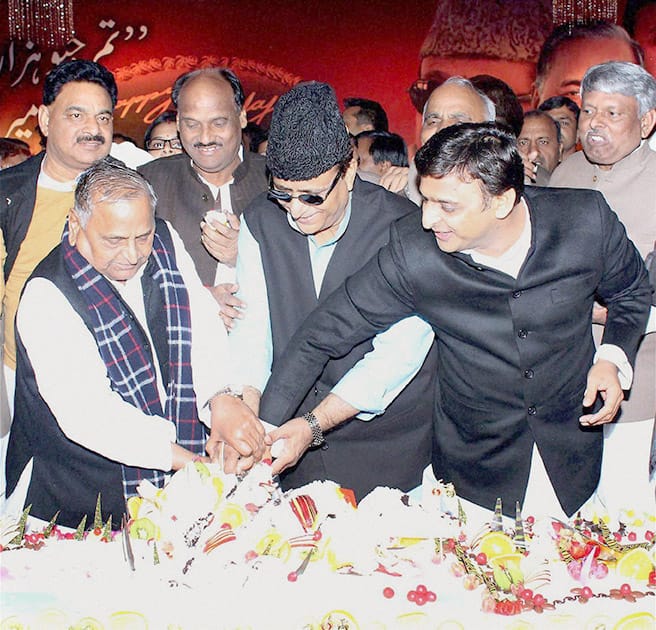 Samajwadi Party supremo Mulayam Singh Yadav with Uttar Pradesh Chief Minister Akhilesh Yadav and Azam Khan cutting cake on the occassion of Mulayam Singh Yadavs 76th birthday.