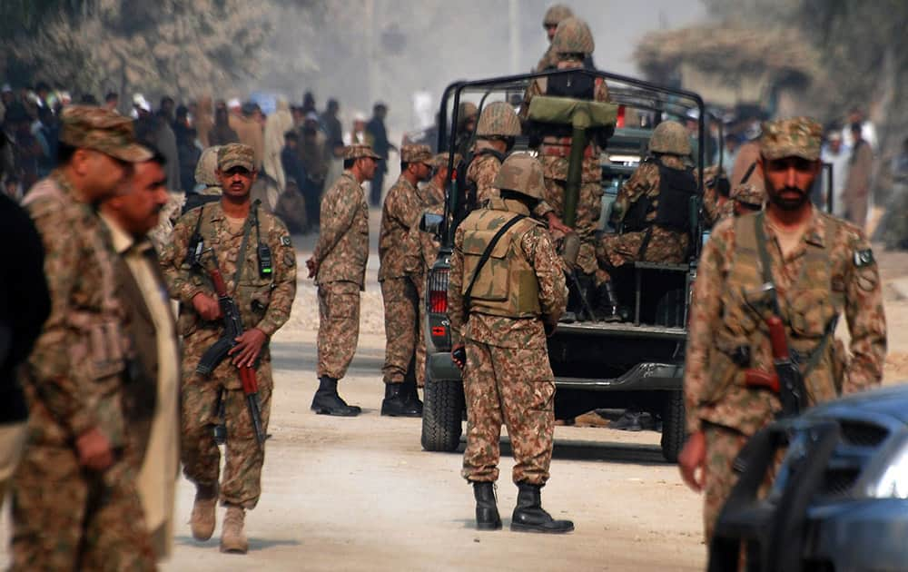 Pakistan army soldiers cordon off the area of a bombing in Peshawar, Pakistan.