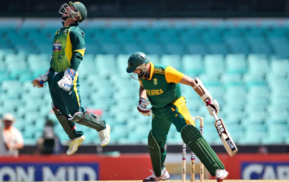 Australia's wicketkeeper Matthew Wade leaps as he celebrates catching out South Africa's Kyle Abbott, right, during their One Day International cricket match in Sydney, Australia.