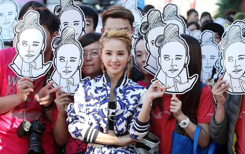 Taiwanese singer Jolin Tsai poses with her fans for a photo during an event to promote her new album 
