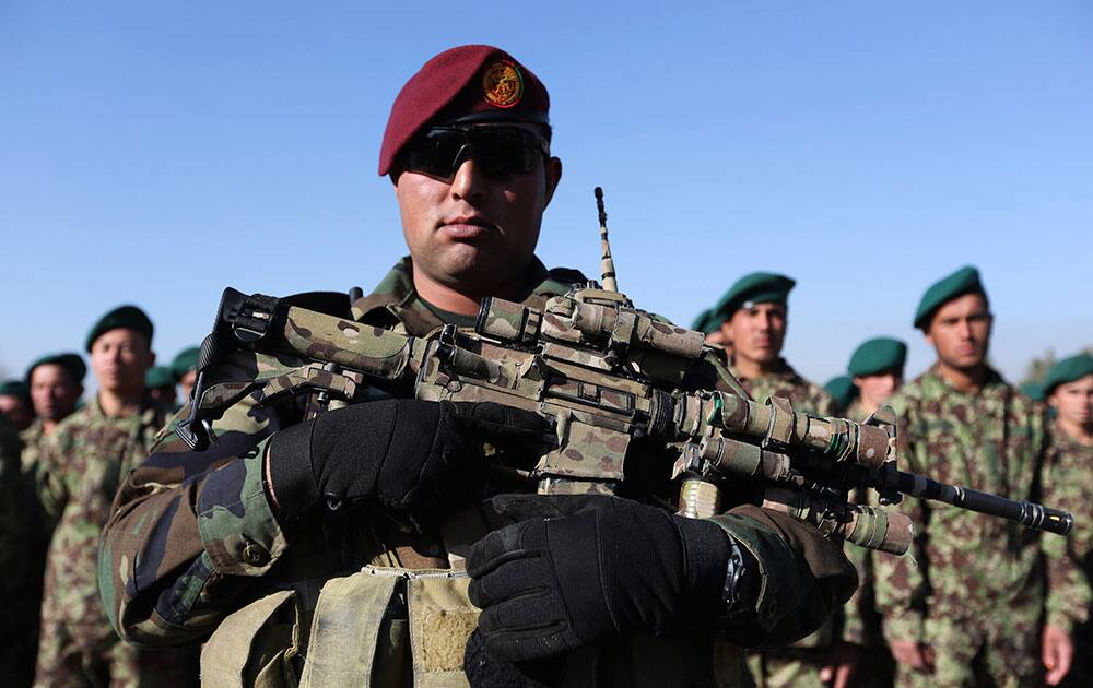 A member of the Afghan National Army stands guard as new members attend their graduation ceremony at the Afghan Military Academy in Kabul, Afghanistan.