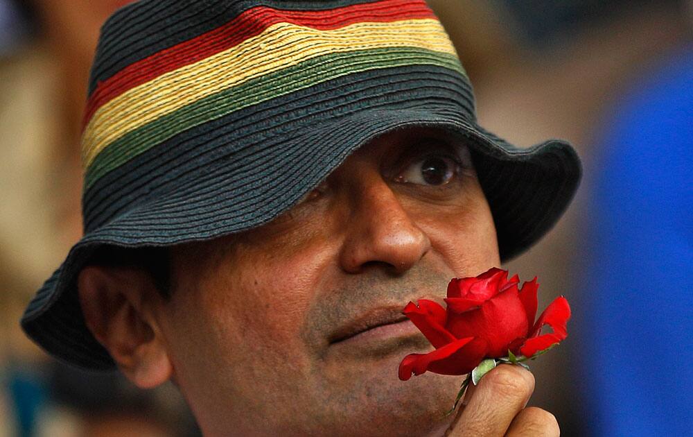 A participant holds a rose as members and supporters of lesbian, gay, bisexual and transgender community, hold a 'Pride March' rally in Bangalore, India.