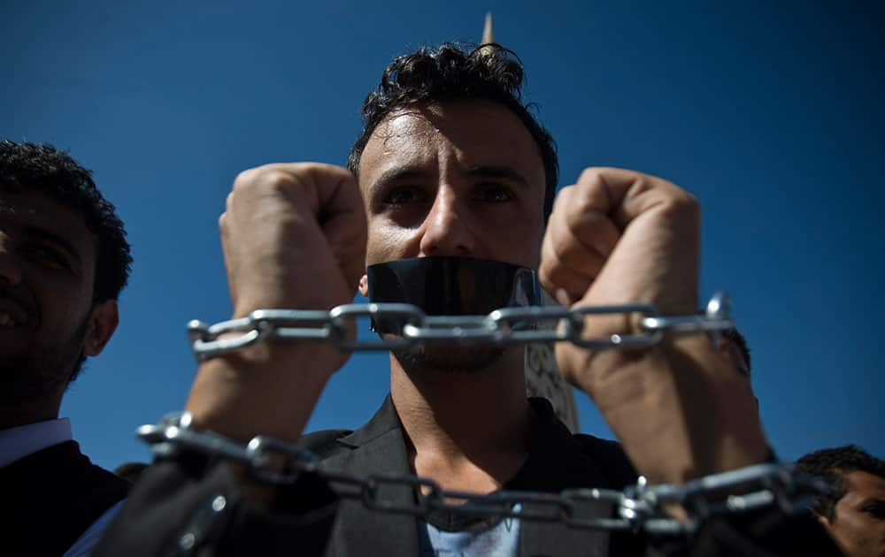 A Yemeni man chains himself to protest against the Shiite insurgency during a rally in Sanaa, Yemen.